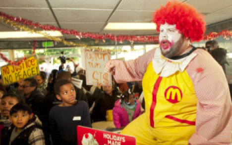 Man dressed in a Ronald McDonald costume at a protest